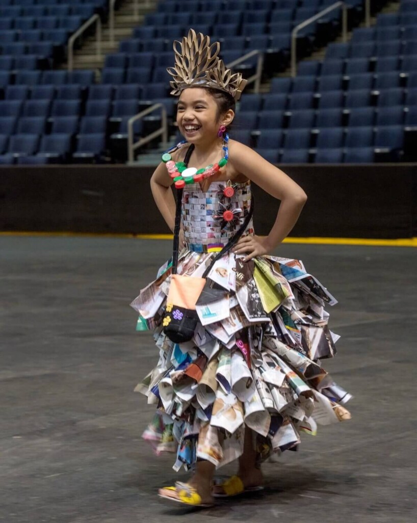 young girl poses in hand made dress