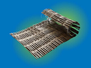 A piece of corrugated cardboard perforated with rows of slits.